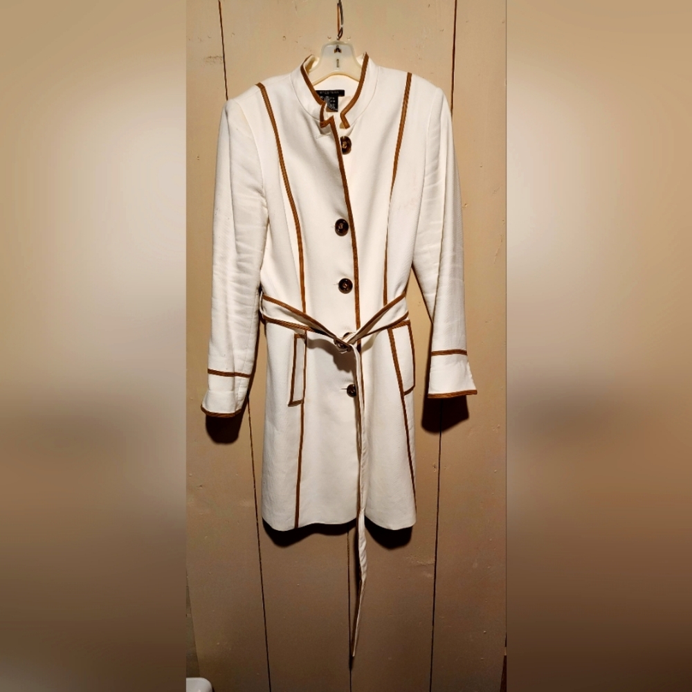 Cream jacket with tan trim. Thigh length.